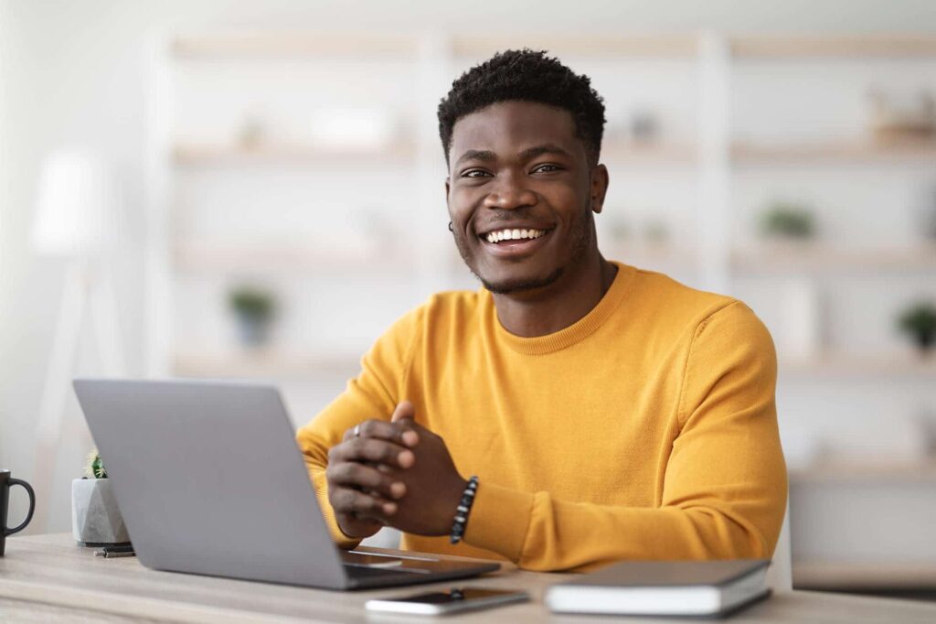 portrait of positive black guy working on laptop 2022 01 06 05 08 07 utc 1 e1650482059706